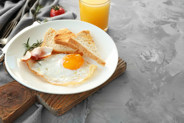 Tasty nutrient breakfast with fried egg on table