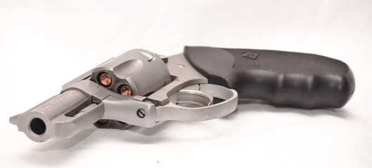 Loaded stainless revolver with a closed cylinder