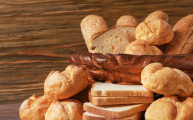 Beautiful composition with variety of bread on wooden background