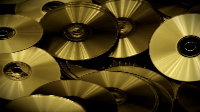 Golden Color Abstract Video of Cds and Dvds Disk Lie on the Table