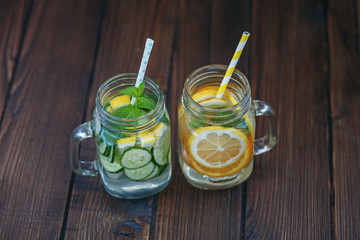 Detox water with cucumber, lemon and mint. Lemonade with orange. Top view. The concept of a diet, a vegetarian, healthy food and a lifestyle.