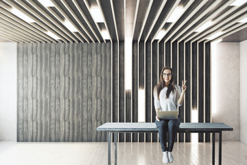 Girl with laptop in empty room