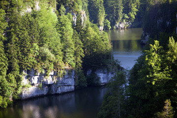Forest landscape in Switzerland near Les Brenets village with the river Doubs