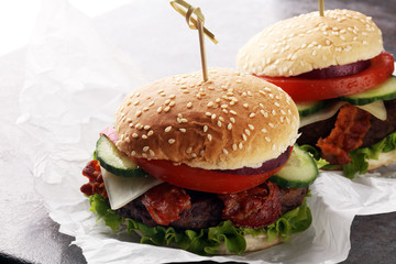 fresh tasty burger on wooden grey background