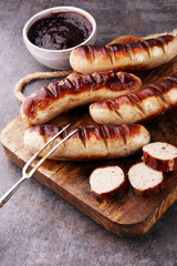 Grilled sausages with sauce ketchup on a wooden table - Home-made Pork Sausages