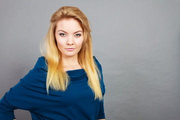 Portrait blonde young woman having serious face expression