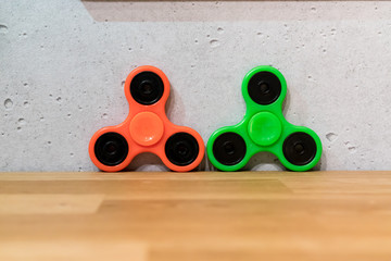 Orange and green fidget spinners
