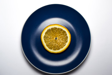 Slice orange on a blue plate