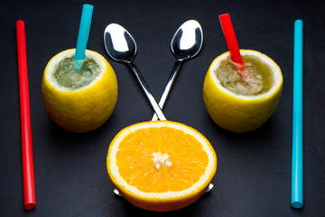 Lemon cocktail and orange on black