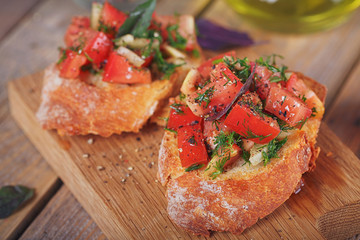 Bruschetta with chopped tomatoes, basil and herbs on grilled crusty bread.