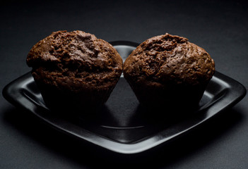 Chocolate cupcakes on black saucer