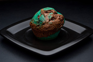 Chocolate mint cupcake on black plate