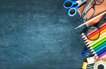 School supplies on black board background empty copy space.