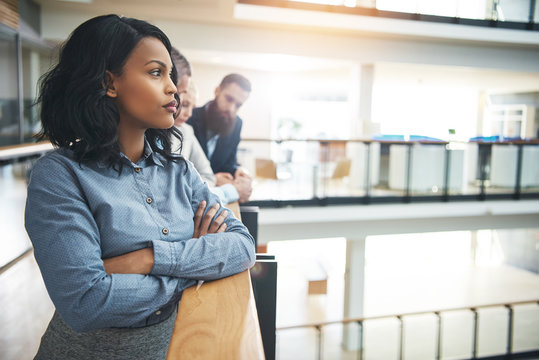 Pretty Black Woman In Office Looking Away And Thinking