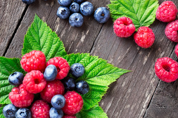 raspberry, blueberry with leaves close up.