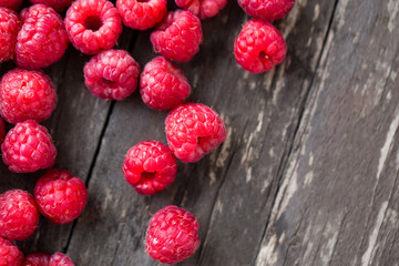 Summer fresh fruits. Raspberry on wooden table.