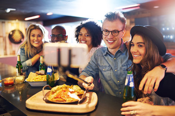 Friends doing selfie with beer at bar