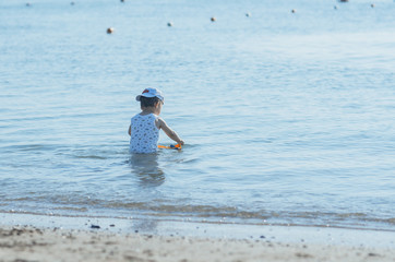 a little boy playing in the sea