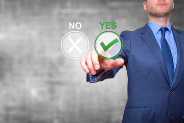 Hand of businessman press Yes button. Concept of decision making. Isolated on grey. Stock Image