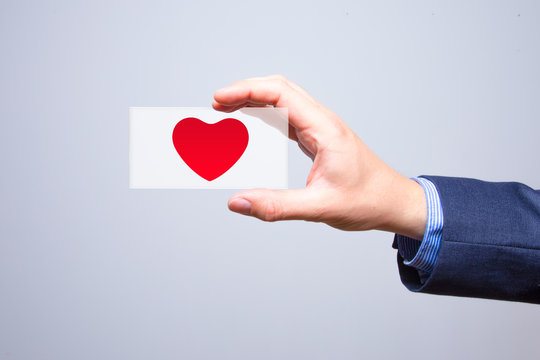 Businessman holding a red heart in his hand - crm - service mind