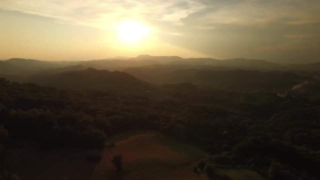 Flying over rural hills in sunset