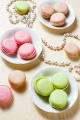 Colourful macaroons on the plates