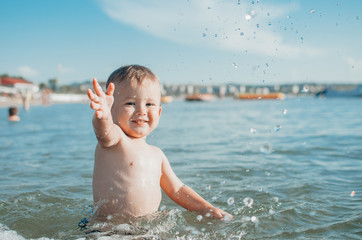 Fototapeta na wymiar Little boy swimming in sea