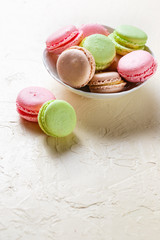 Colourful macaroons on the plates