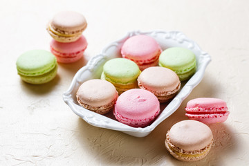 Colourful macaroons on the plates