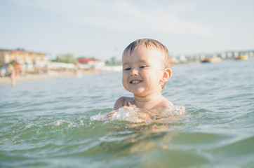 Fototapeta na wymiar Little boy swimming in sea