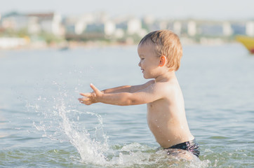 Fototapeta premium Little boy swimming in sea