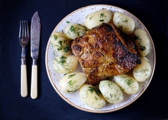 Pork baked in aromatic spices with olive oil, boiled potatoes and dill.