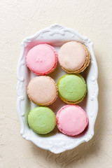 Colourful macaroons on the plates