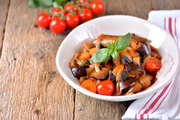Eggplant stewed with mushroom, onion, cherry tomato, garlic and basil leaf. Rustic style.