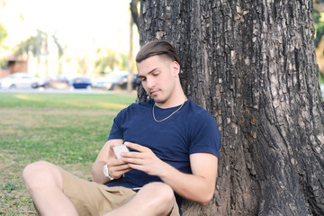 Latin man typing on his phone.