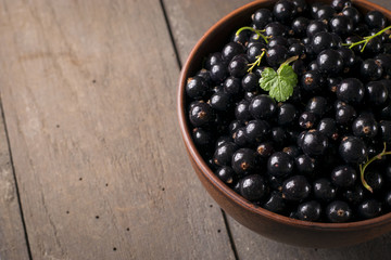 Black currant on a wooden background