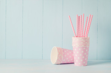 Pink paper cup and Straws on blue background