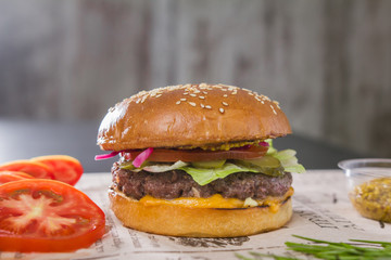 A fresh tasty burger with sliced tomato and green mustard