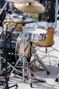 drum set with microphones standing on outdoor stage