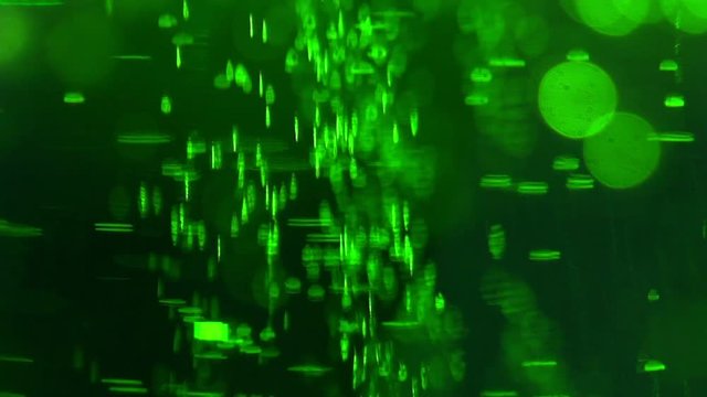 Liquid is bright green in a glass chemical flask: texture and processes of venturi. In vitro: liquid in chemical container extra close-up. Concept chemistry, laboratory, chemical liquids.