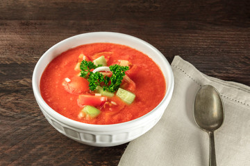 Bowl of gazpacho soup on rustic texture with copyspace