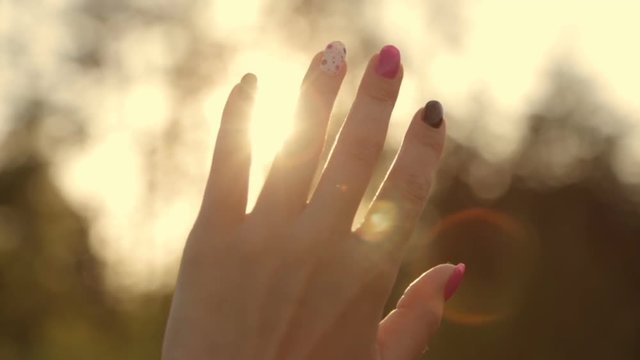 Sun rays through a woman's hand