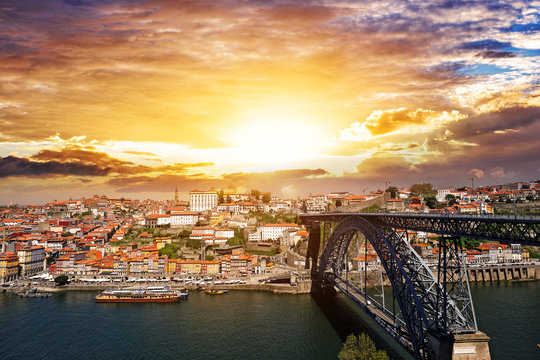 Beautiful sunset in Porto, Portugal. Dom Luis bridge and Douro River.