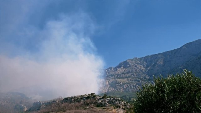 Forest fire burning below mountain Biokovo in Croatia