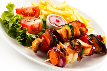 Kebabs - grilled meat and vegetables on white background 