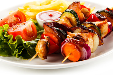 Kebabs - grilled meat and vegetables on white background 