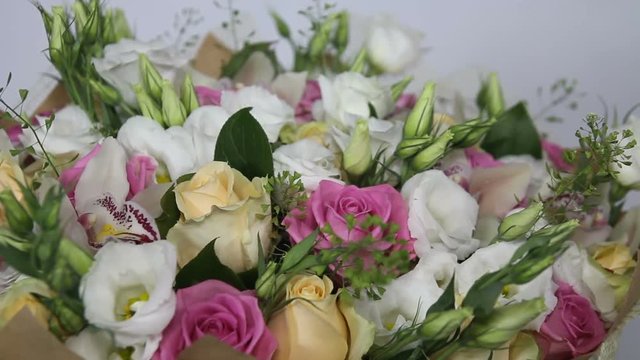 Close up of turning bouquet of pink roses and eustoma