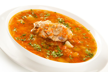 Vegetable soup with pork on white background