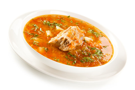 Vegetable soup with pork on white background