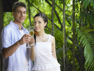 Man and woman with champagne glasses posing for the camera